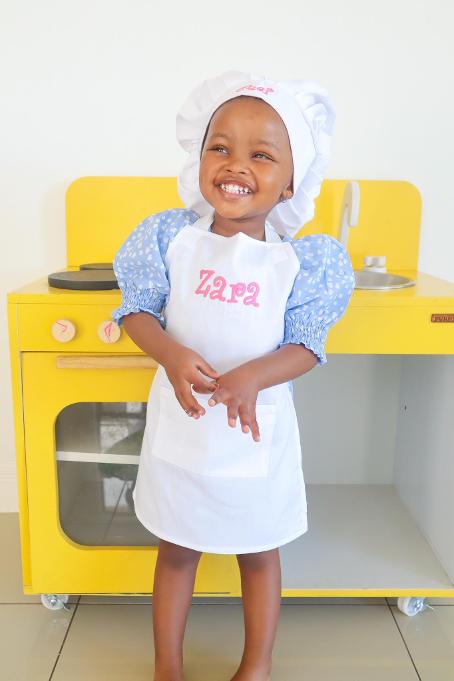 girl in white chef apron and hat- handmade by 3rd Kid creations